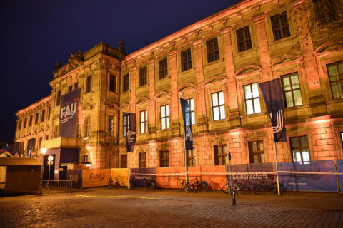 FAU's Schloss is illuminated in orange.