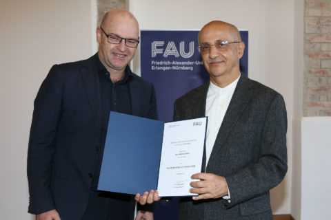 Two men holding up a certificate.