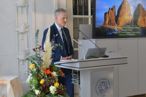 A man stands on a pedestal and gives a speech.