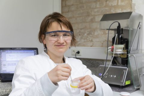 Portrait of a woman with protective glasses in a laboratory