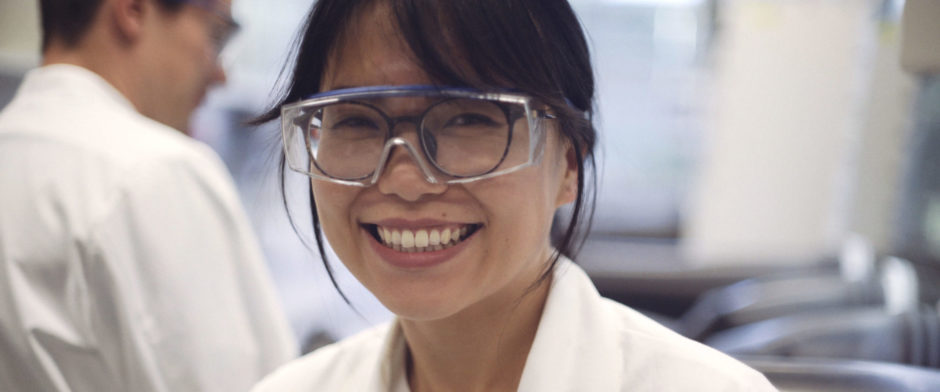 A women with glasses in a laboratory.