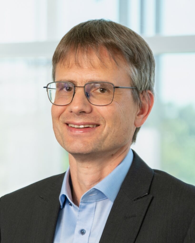 A Man with glasses in a suit.