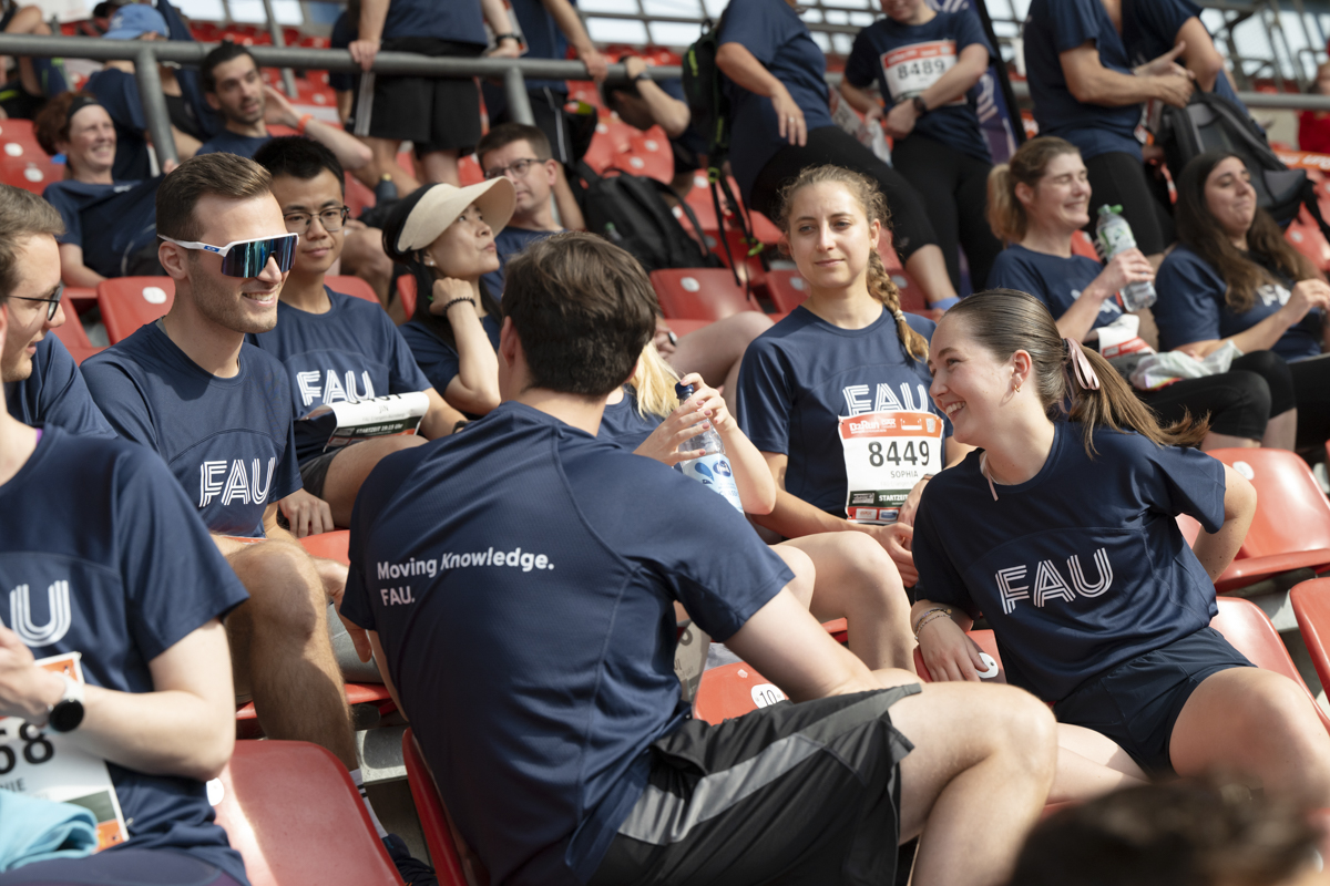 The FAU running team waiting at the B2Run in Nürnberg, chatting with each other.