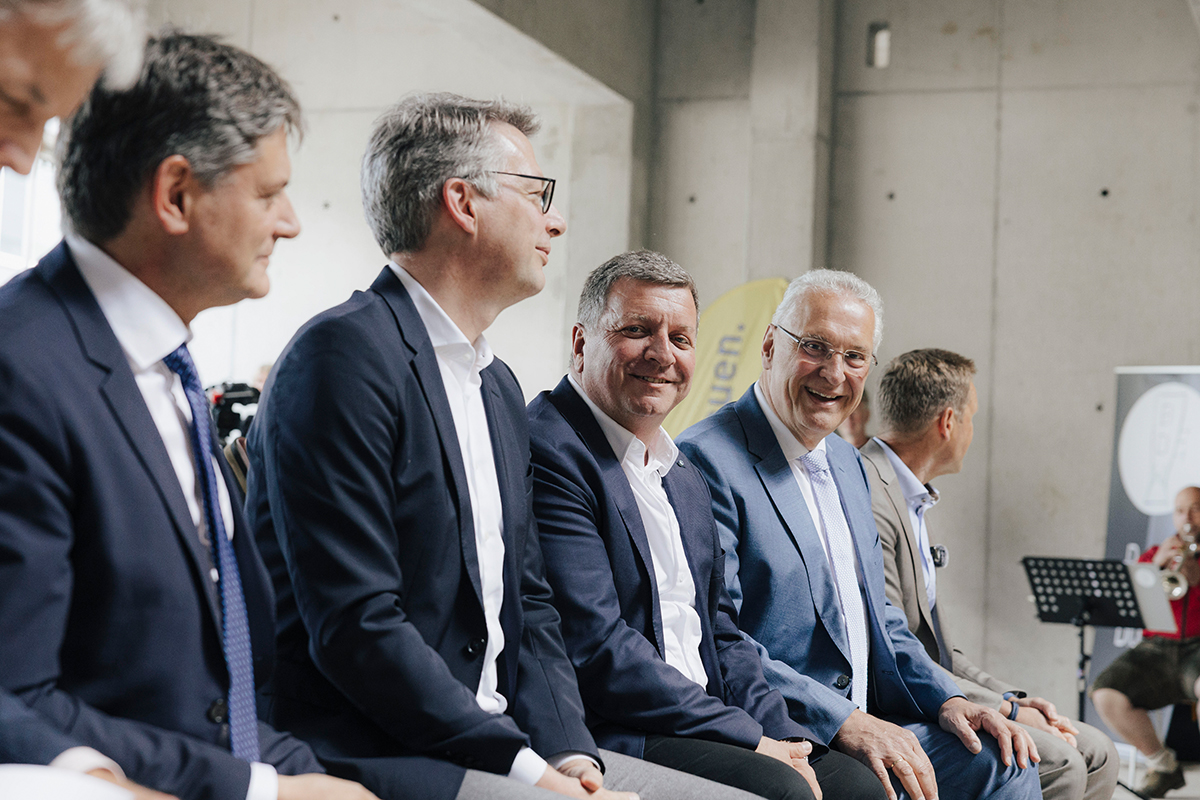 3 Ministers and FAU President sitting on a bench.