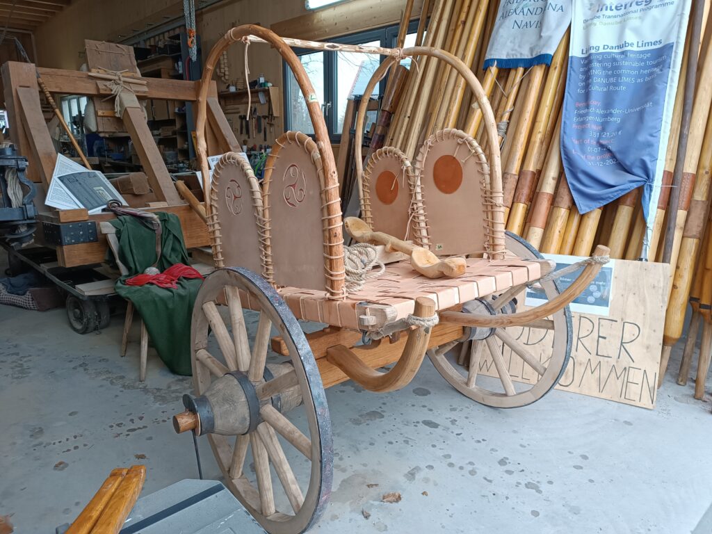 Completed Celtic wagon, a wooden wagon with two wheels that is pulled