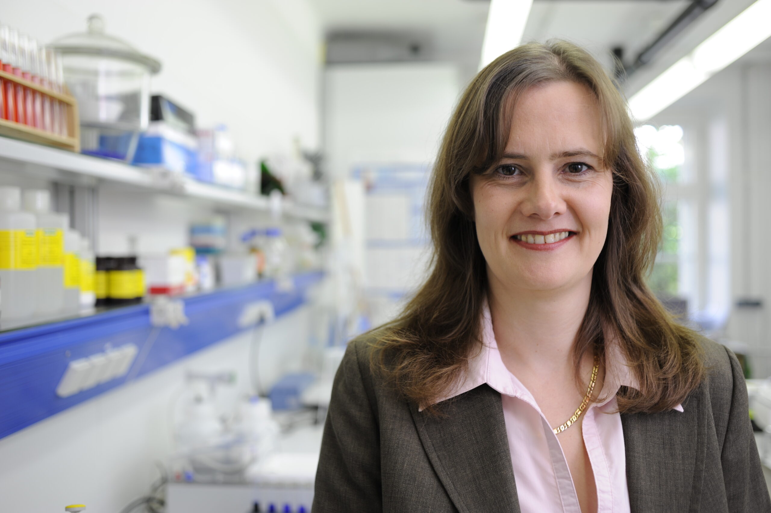 Woman in a lab smiles