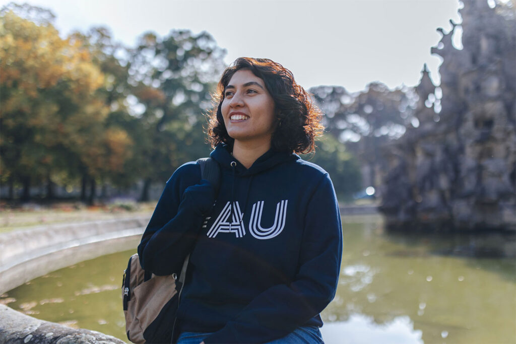 A student is sitting at a fountain.