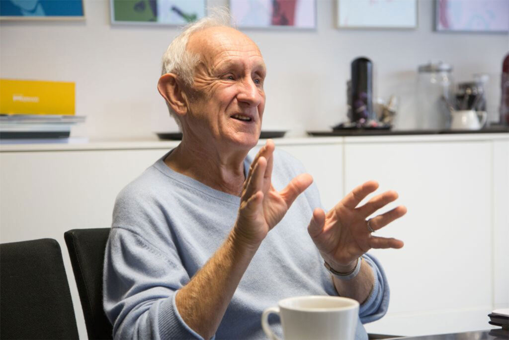 John Bessart is sitting down, explaining something.