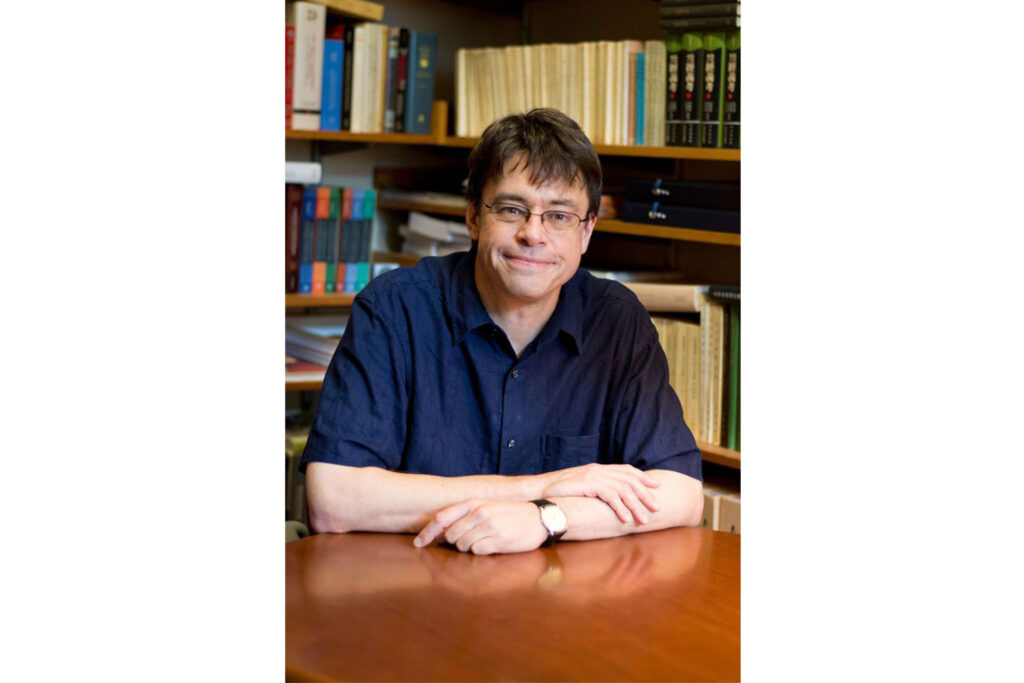 Michael J. Puett sitting at a table.