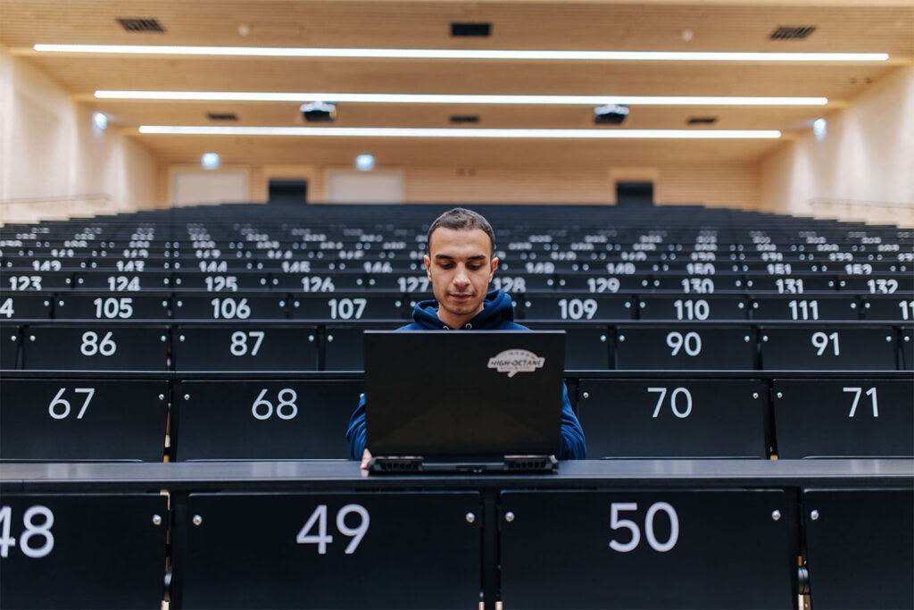 A student sitting in a lecture hall.