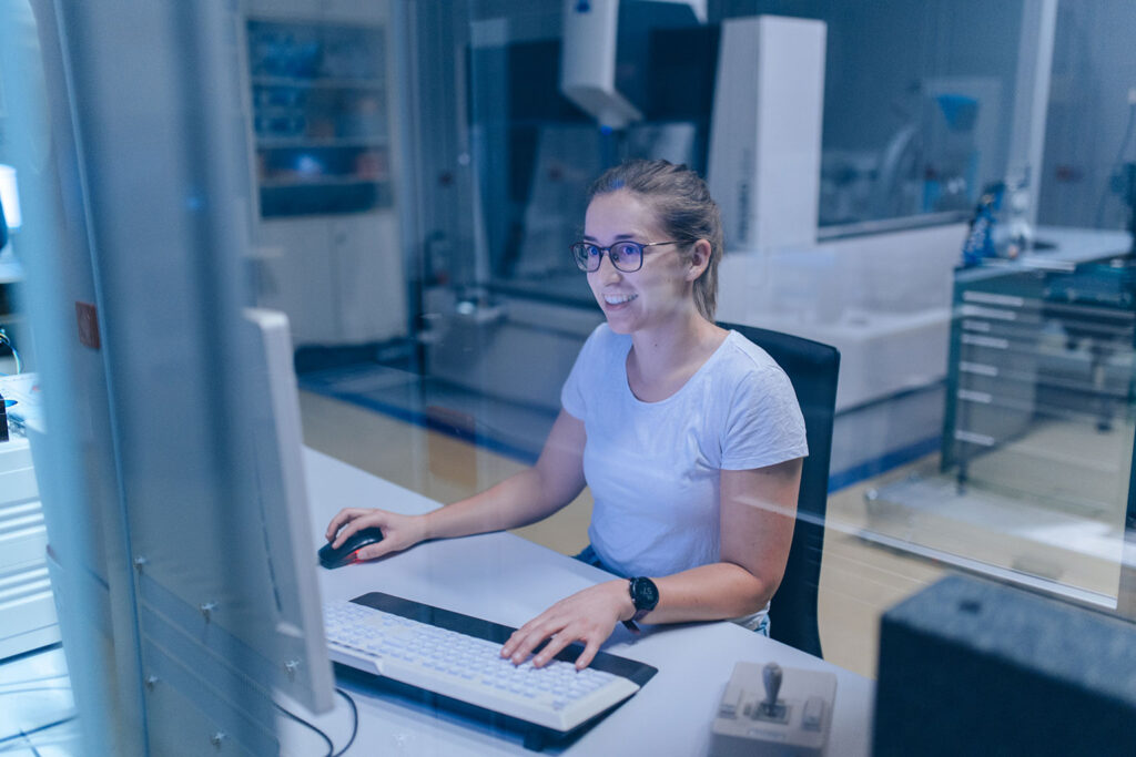 An FAU researcher sitting at a PC in a laboratory.