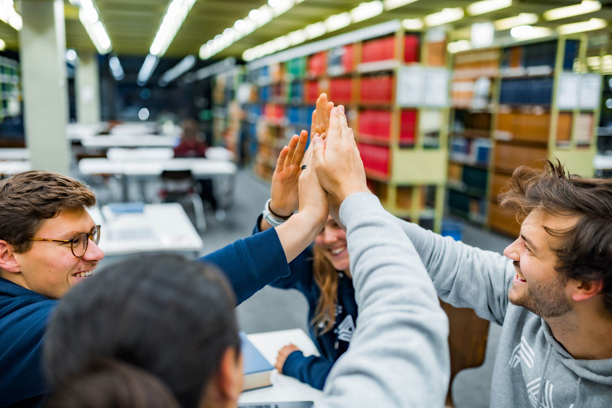 Menschen geben sich ein High Five.