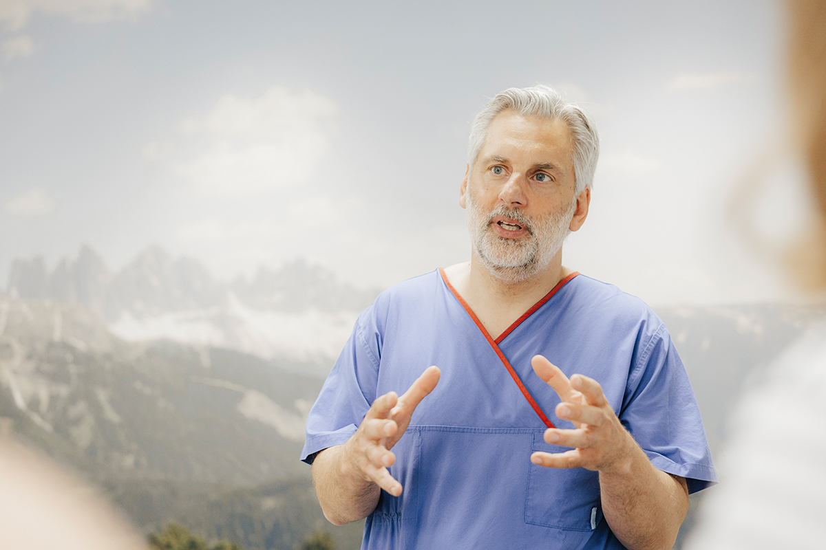 Prof. Schnell is explaining something, both his hands are raised.