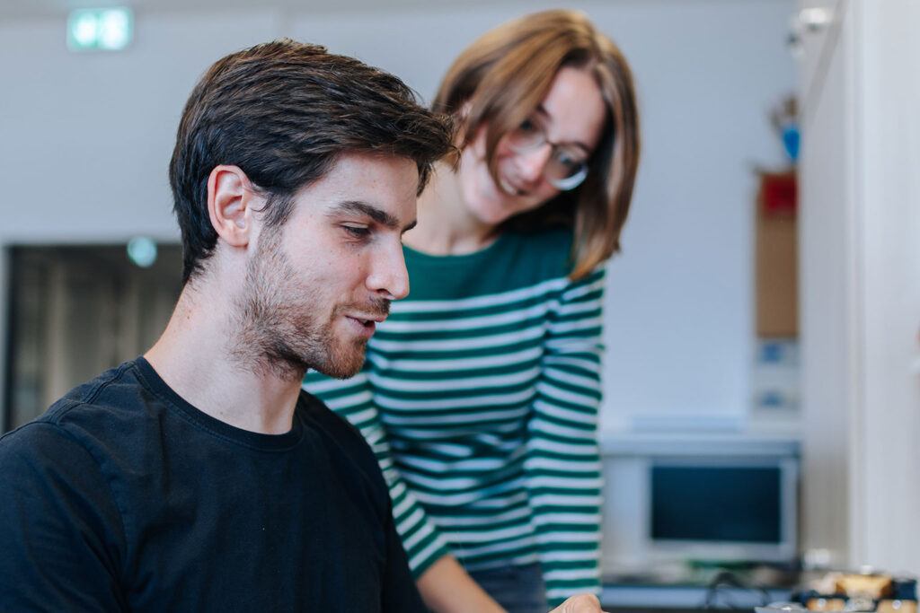 Zwei Forschende der FAU an einem Schreibtisch.