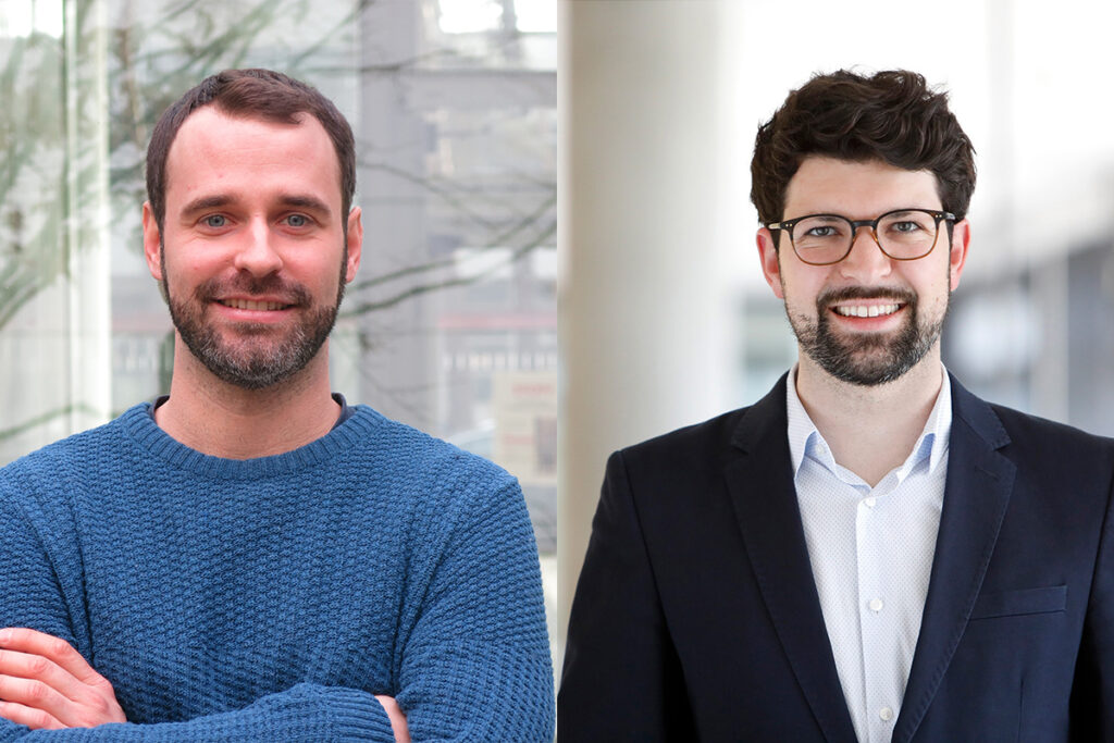 Bassani, a man with a beard, short light brown hair and a blue sweater, has his arms crossed. Meier, a man with dark hair and glasses.