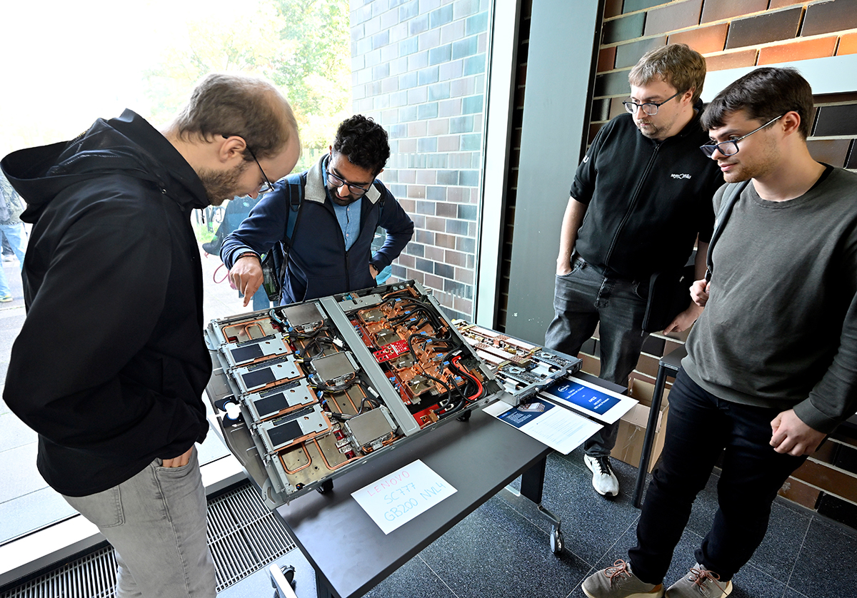 Several young men look at Helma components