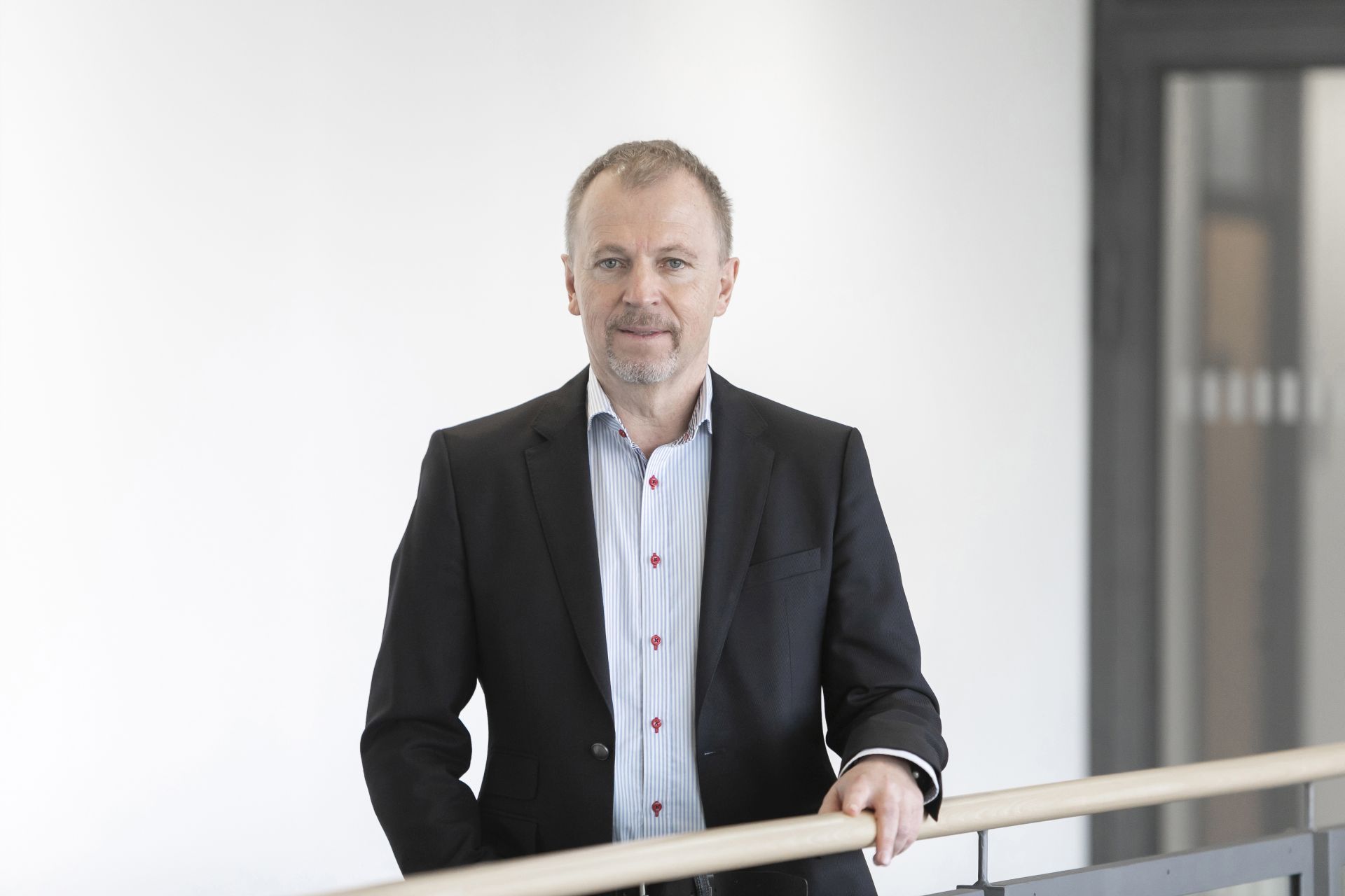 Andreas Hirsch steht an einem Treppengeländer.