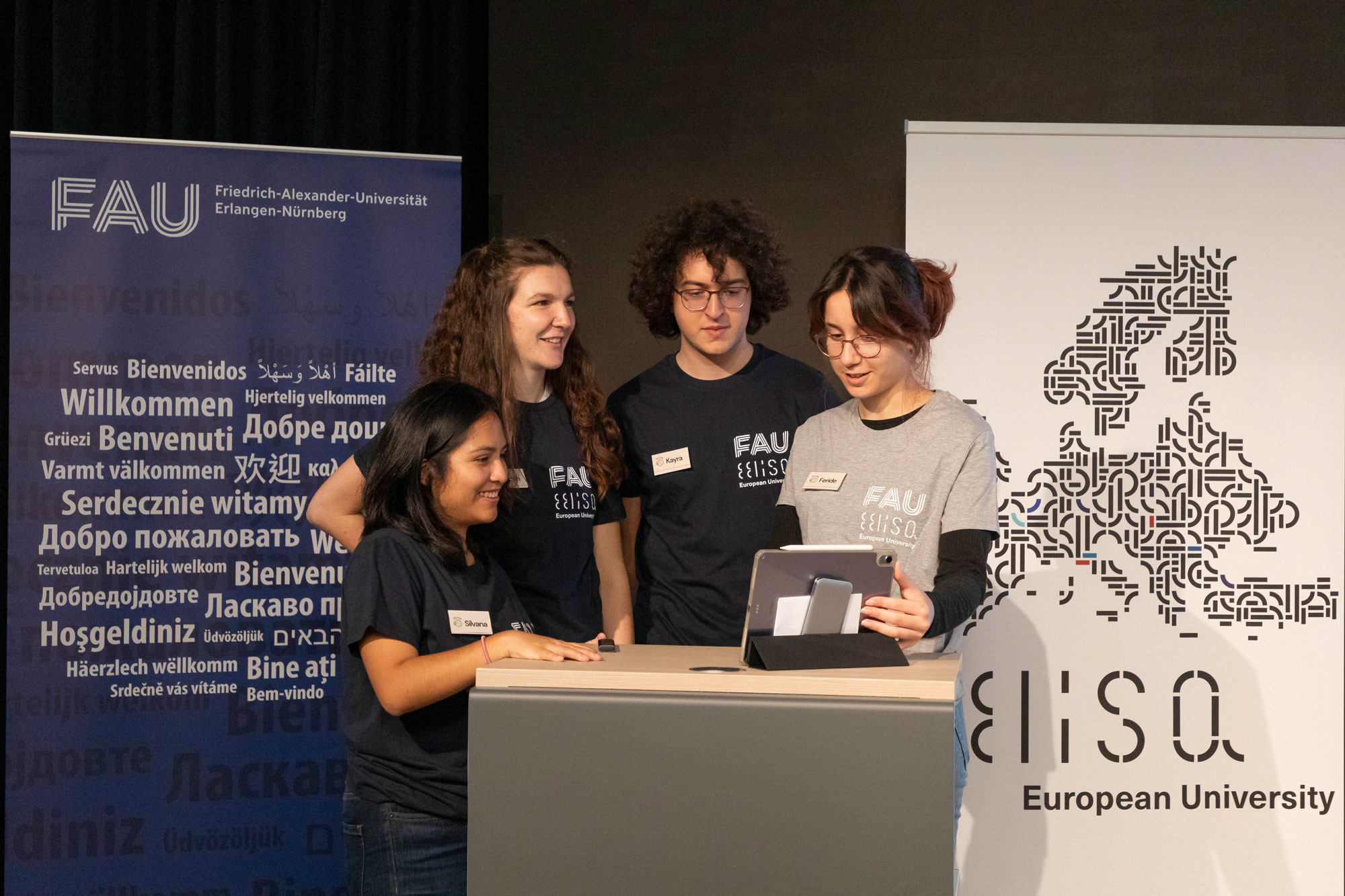 Four students on a stage.