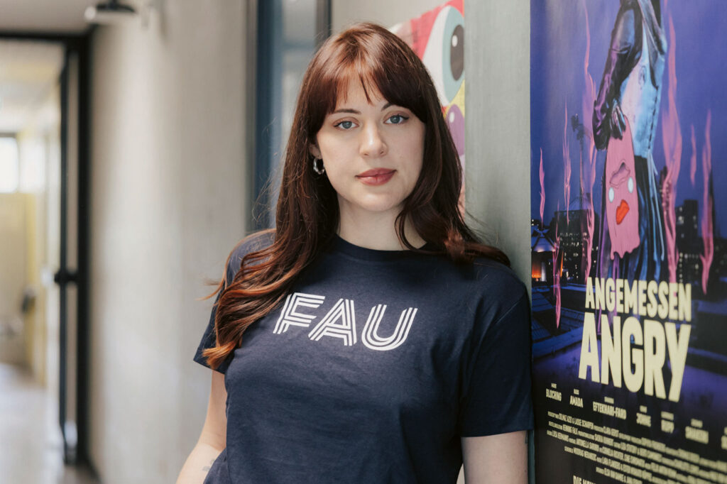 Jana Forkel in front of a movie poster.