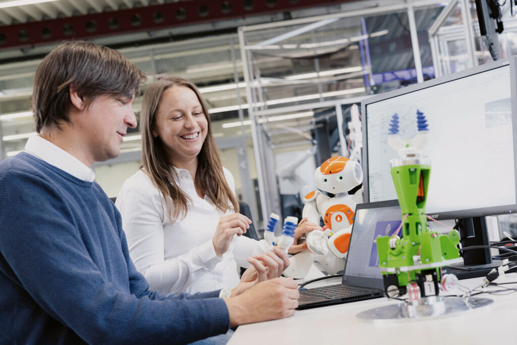 Two researchers working with robots.