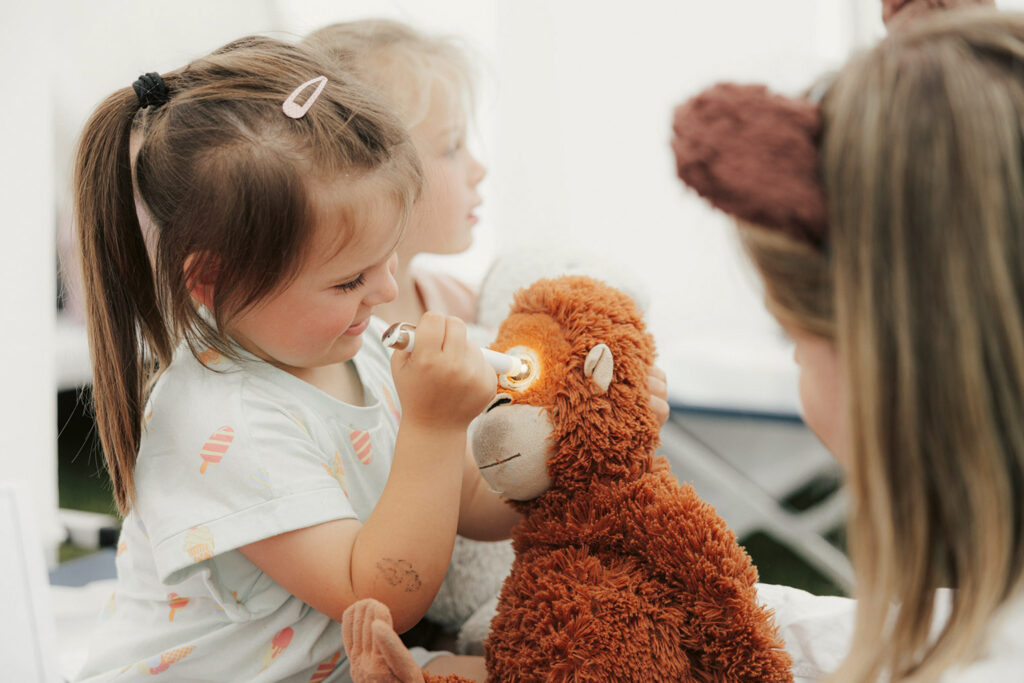 A girl with a stuffed animal.