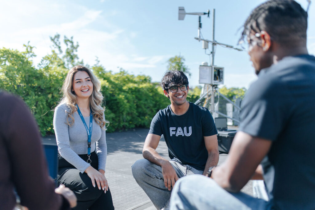 Students sit together.