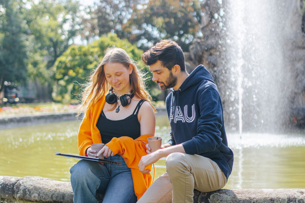 Twos students looking in a tablet.