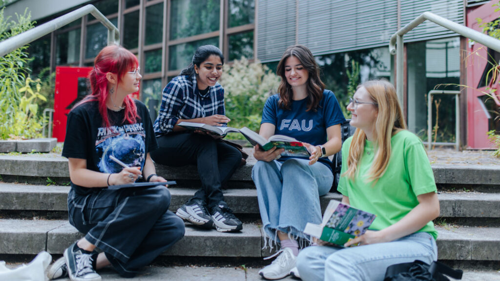 Students sit together learning.