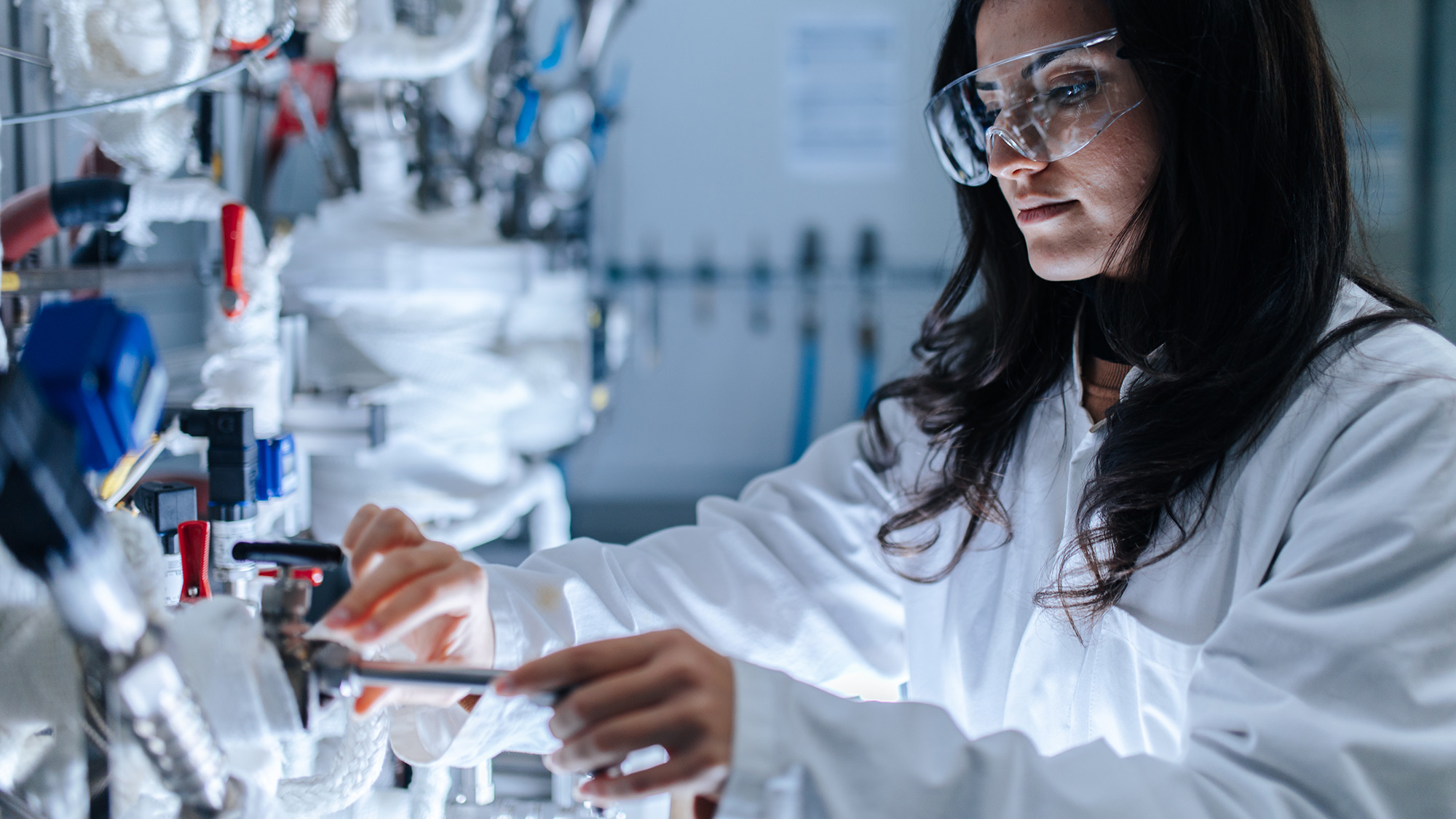 A researcher at a complex machine.