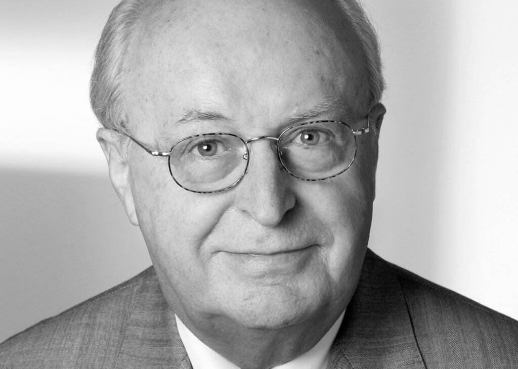friendly elderly man with round glasses and bald head