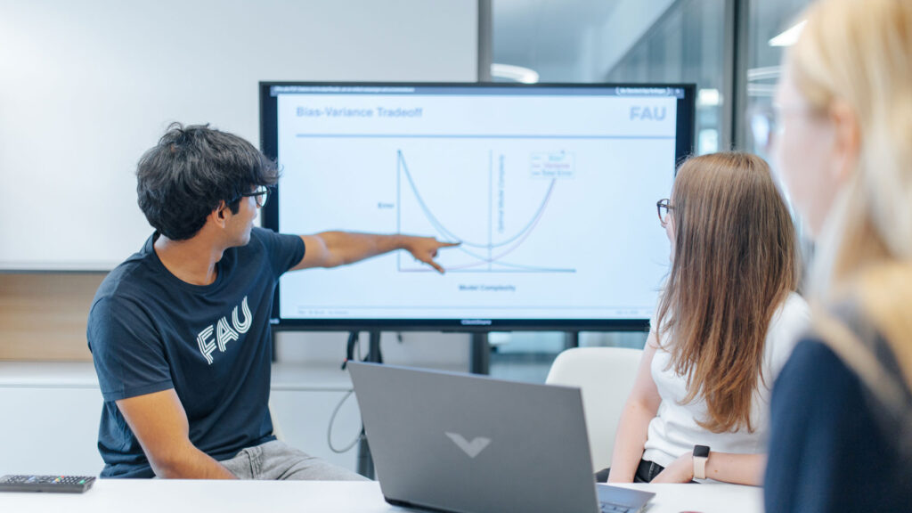 Lecturer points to the smartboard.