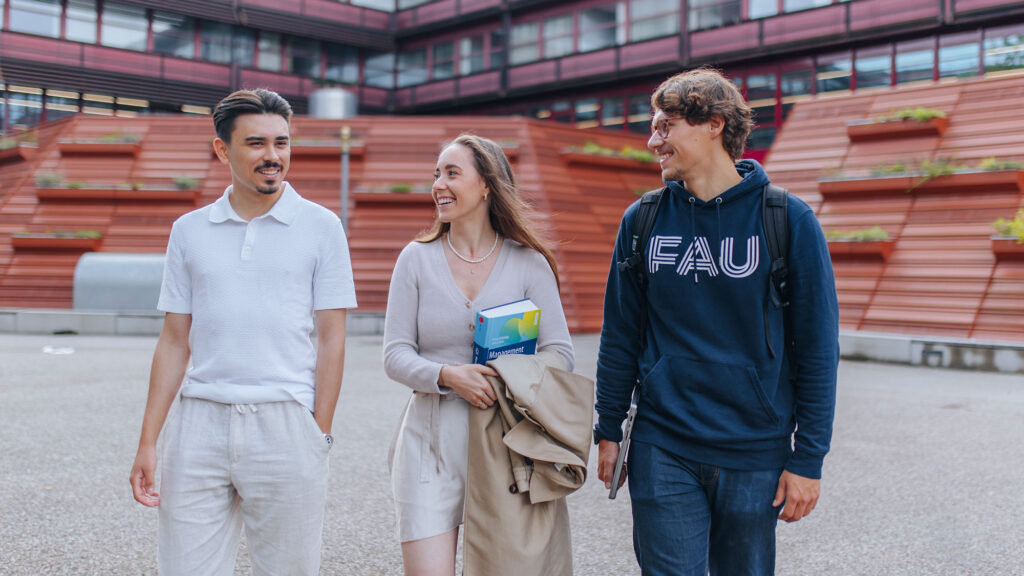 Three students outside on the campus.