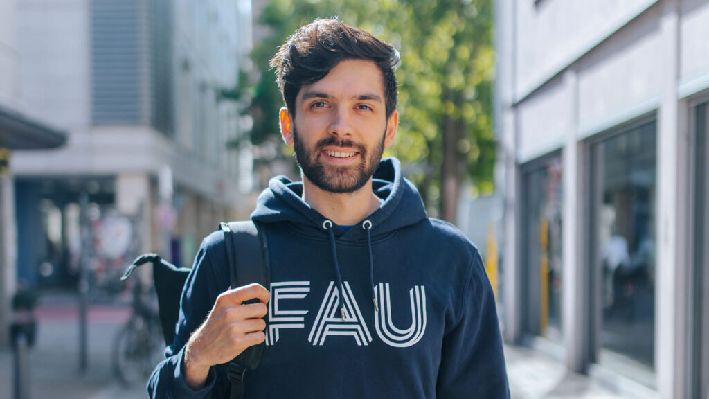 Student with FAU hoodie smiles.