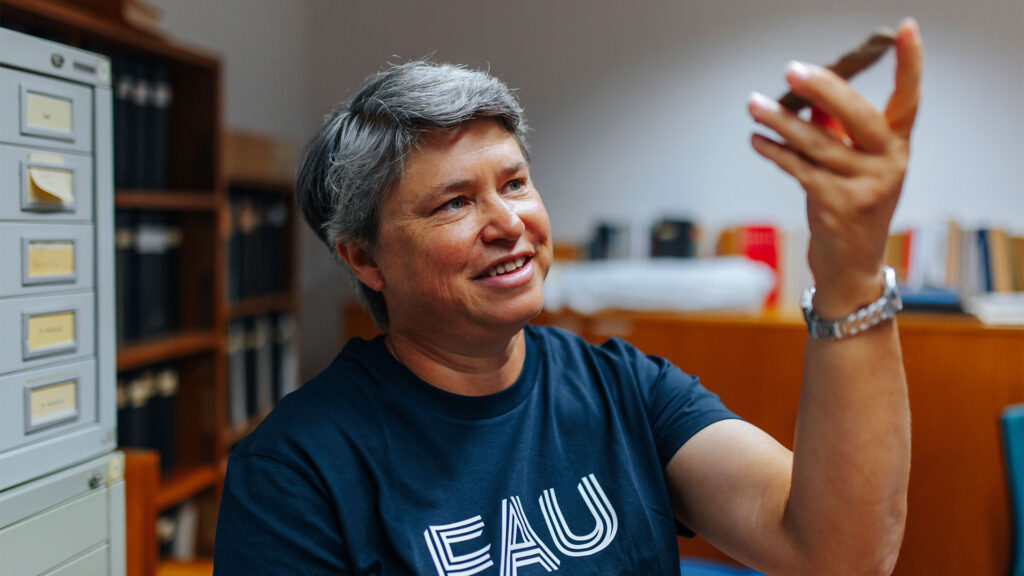 Scientist with FAU shirt investigating.