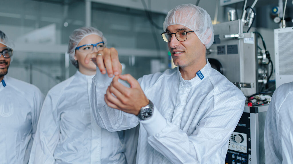 A researcher shows other researchers something.