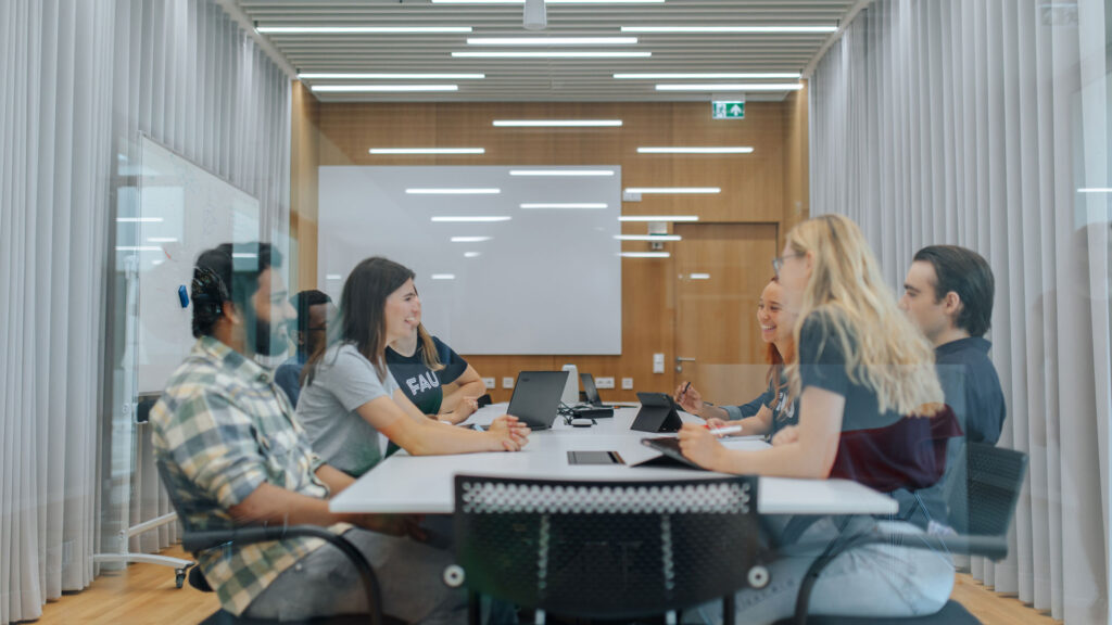 Students sitting together in a meeting room.